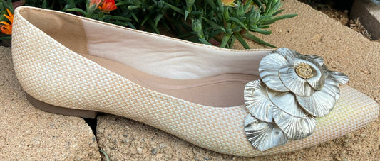 Flat closed shoes, beige neutral, silver flowers accent on top.