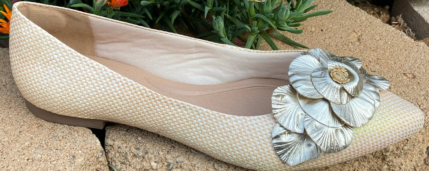 Flat closed shoes, beige neutral, silver flowers accent on top.
