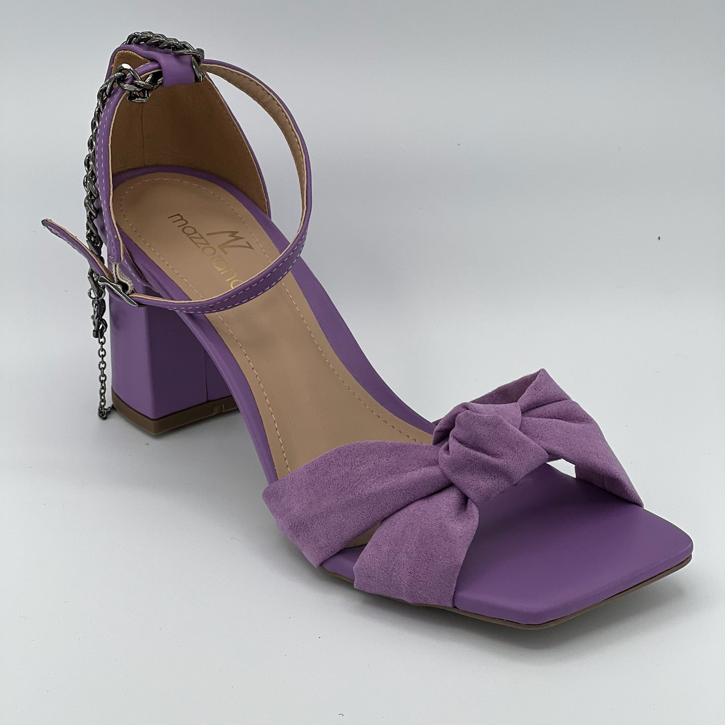 Light purple lavender sandals with chain accent, block hill, closure in the back.. Side view.
